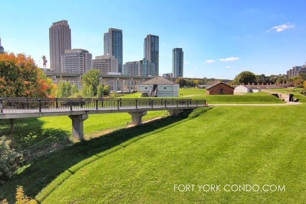 Green hills of historic Fort York in front of the Fort York Condos